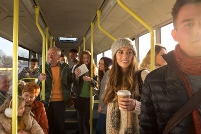 People of all ages riding a city bus