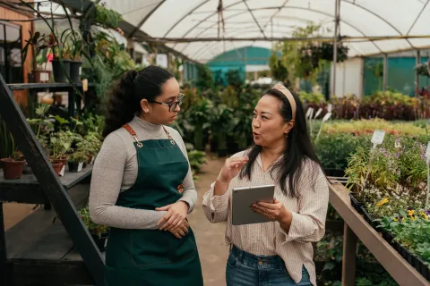 Small business owner directing employee in a flower shop