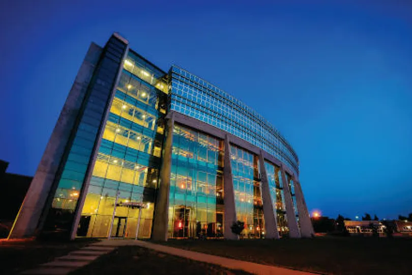 This image depicts a Lakehead University building at night.