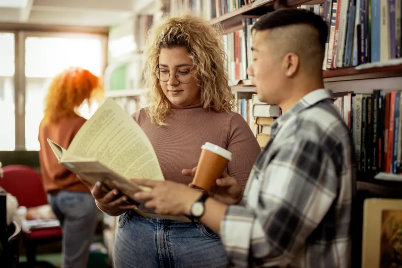Two Students Talking in the School Library