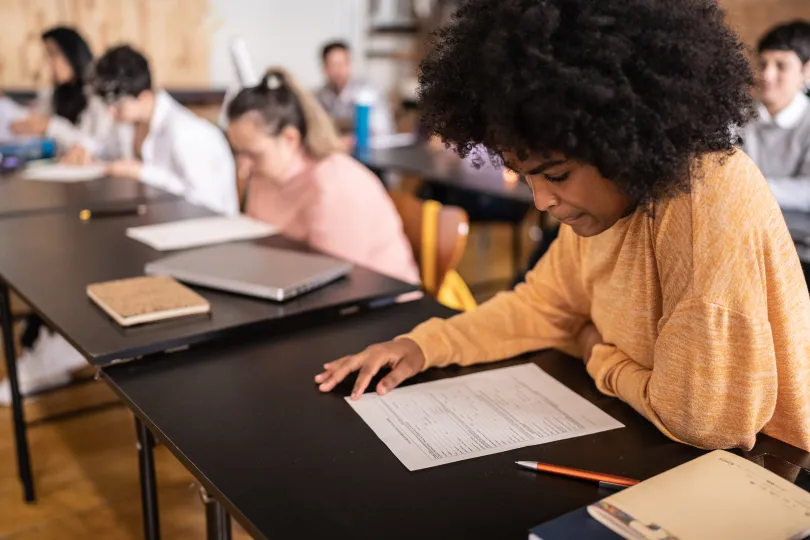 Young woman doing a test in the classroom