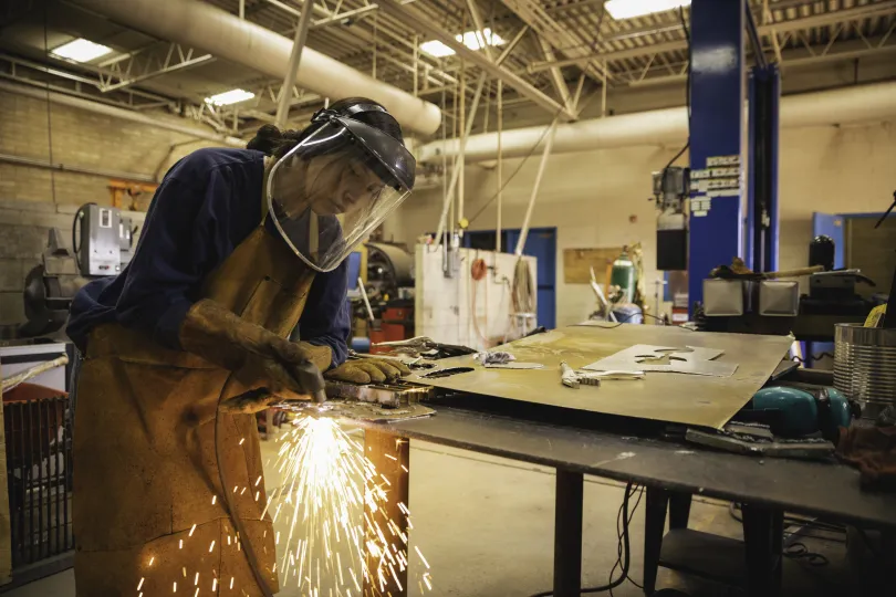 female apprentice practicing her welding skills