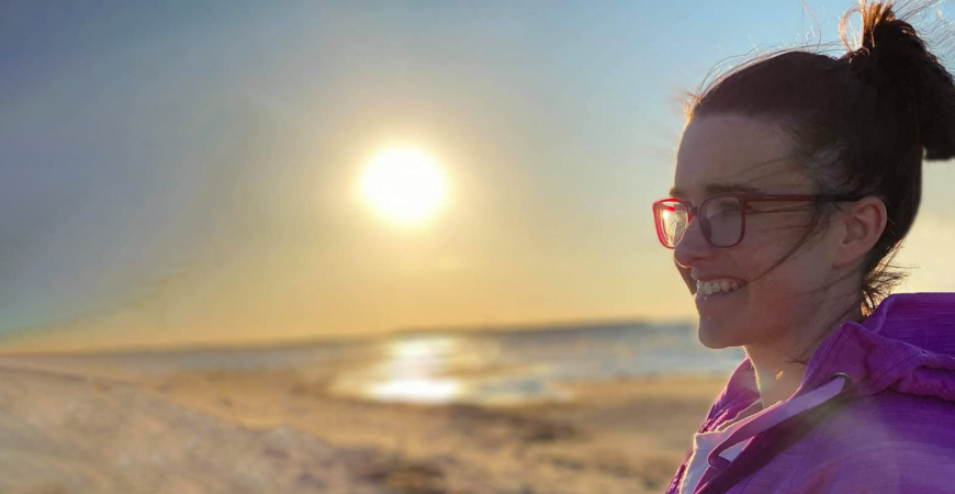 Kailha debout à la plage devant un couchez du soleil