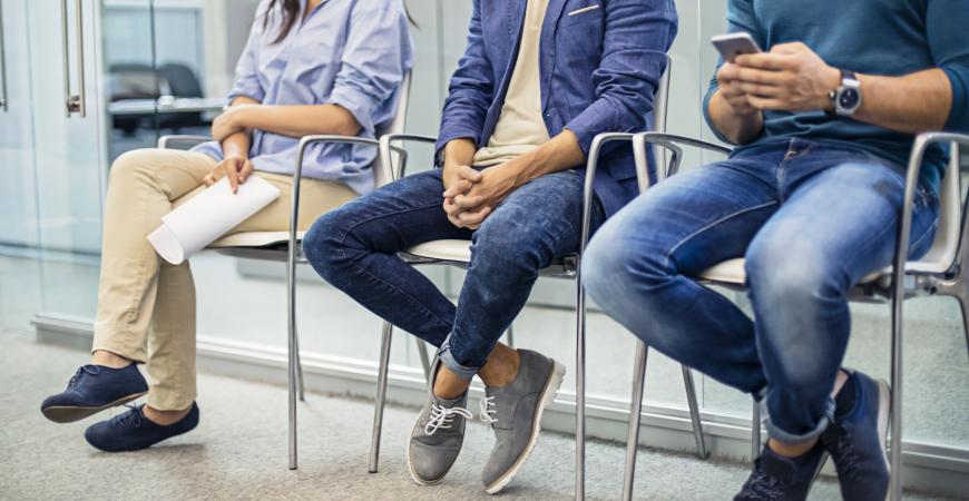 3 individuals sitting in a waiting room