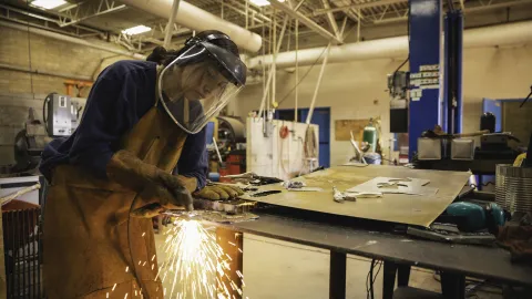 female apprentice practicing her welding skills