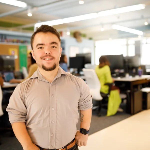 Happy man in the office smiling to the camera