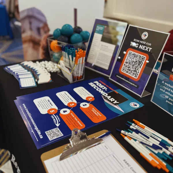 TRG booth with promotional materials and posters