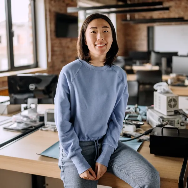 Young casually clothed beautiful woman posing in the office