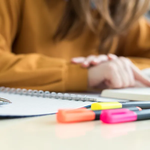 female college Student in class, reading textbook. Focused student in classroom