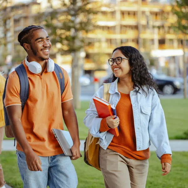 Male and female student chatting on campus