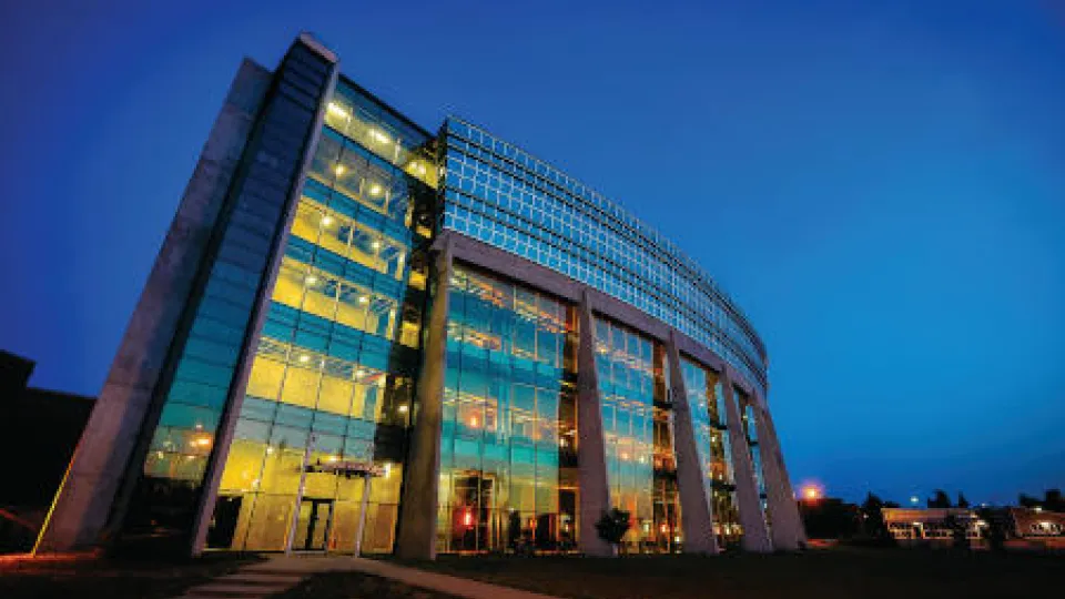 This image depicts a Lakehead University building at night.