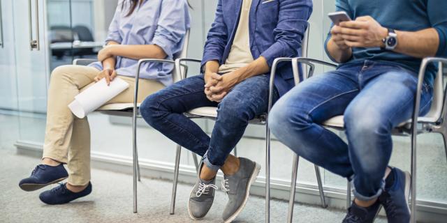 3 individuals sitting in a waiting room