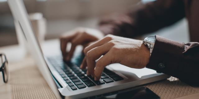 Student typing on a laptop